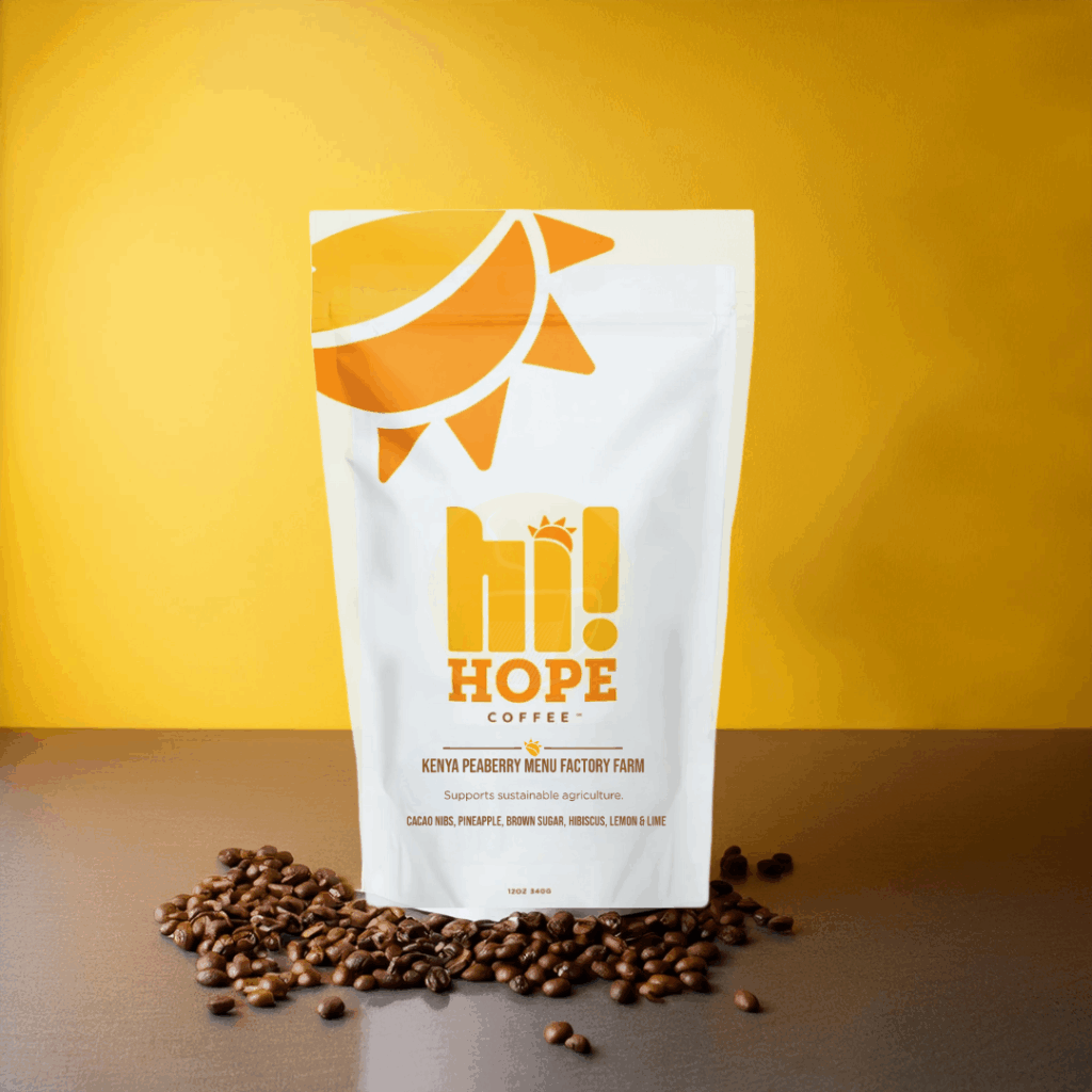 Bag of Hi Hope Kenya Peaberry coffee from Coroco on yellow background with scattered coffee beans, highlighting sustainable and single-origin roast