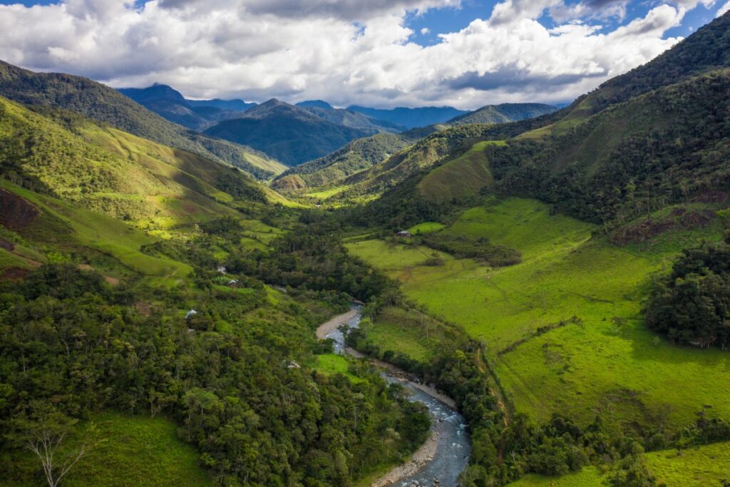 Aerial view of green mountain valleys and river in Cajamarca, Peru

